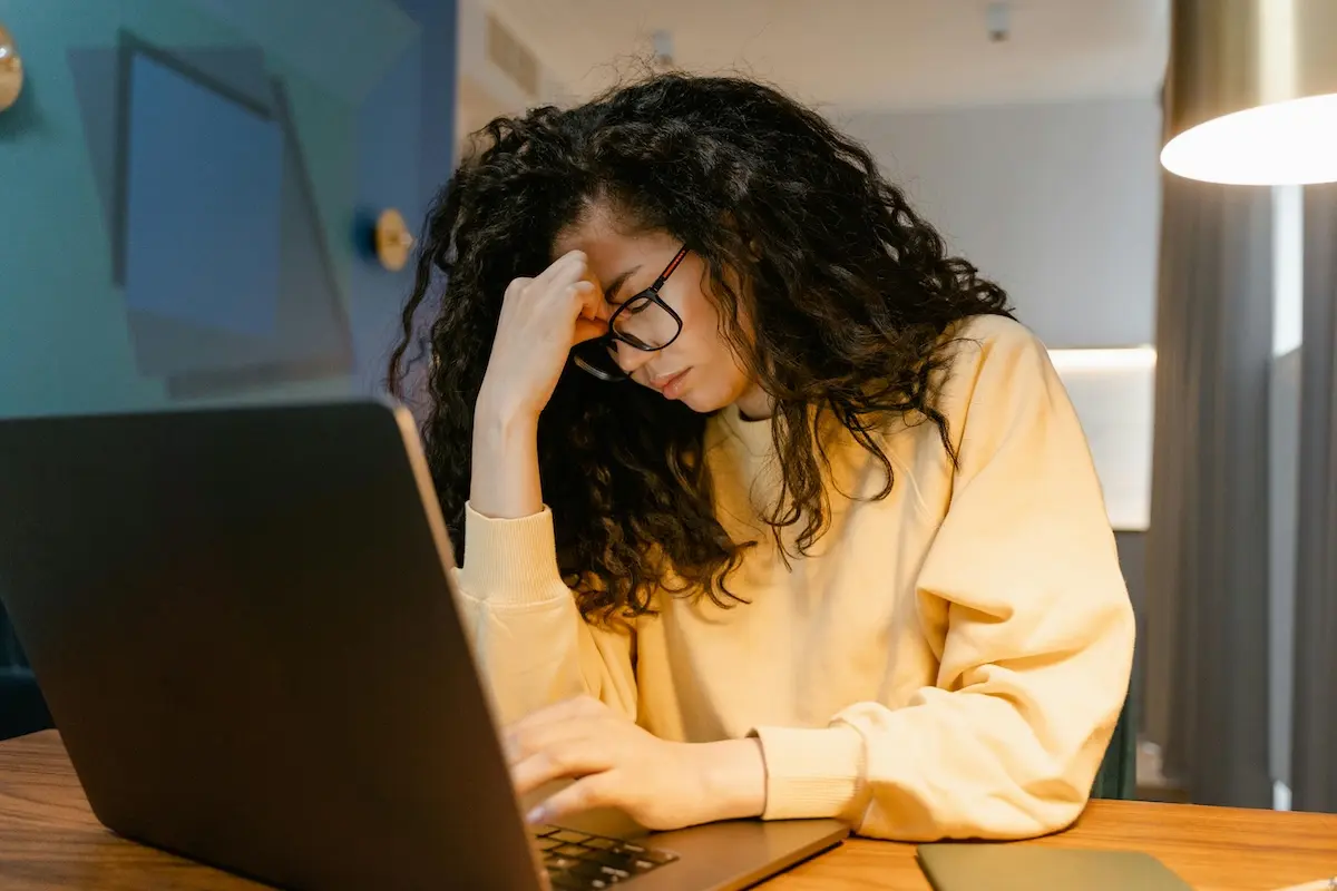 Person frustrated in front of a laptop