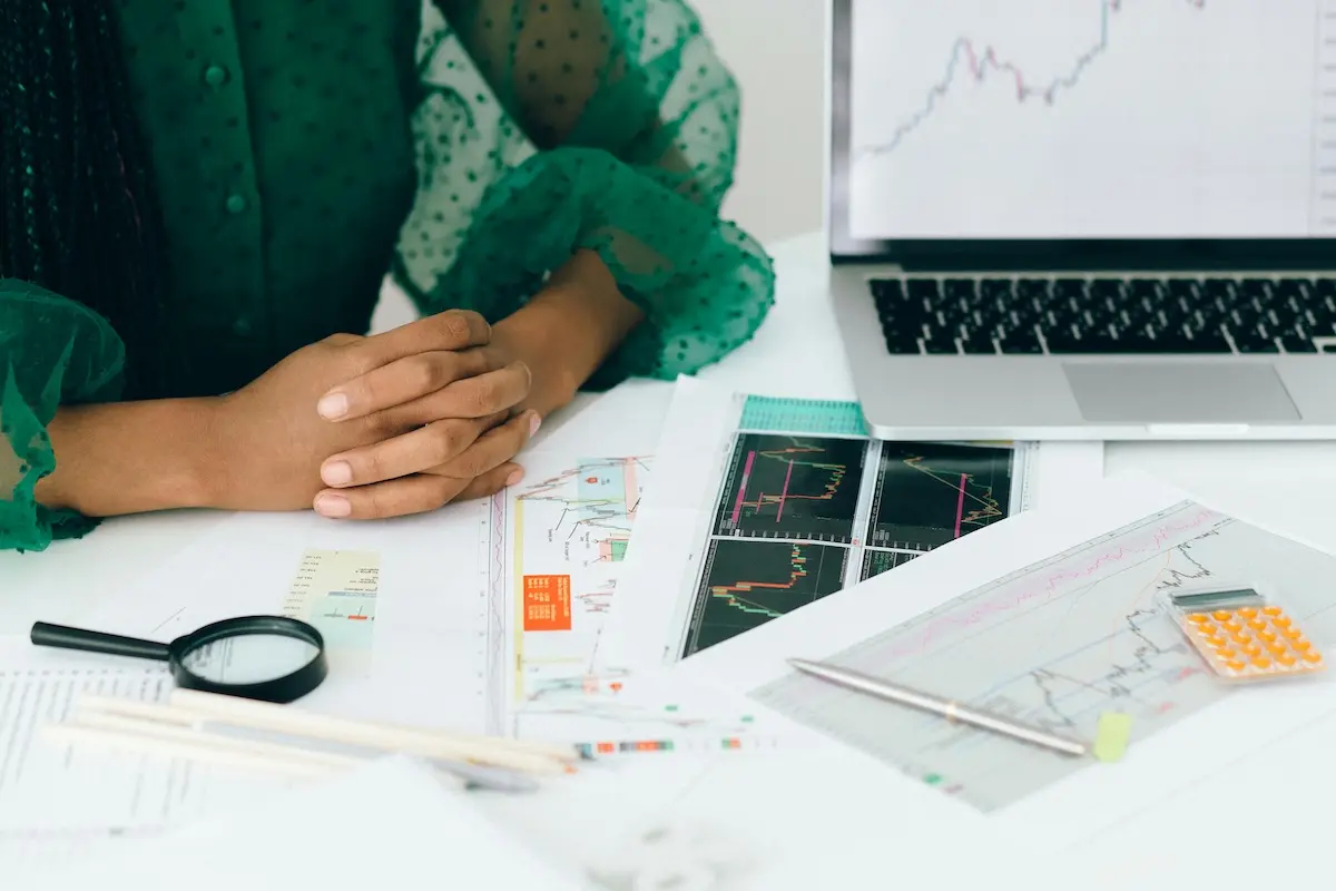 Person looking at multiple printed-out graphs